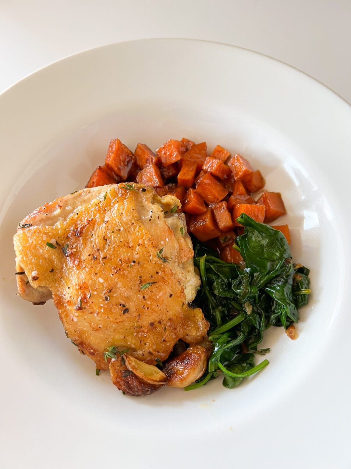 Sage and Thyme Crispy Chicken Thigh, Candied Yams, and Spinach SHEtrition